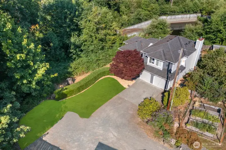 Expansive back yard w/ outdoor kitchen, multiple entertaining areas, Swim Spa & garden beds