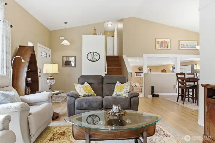 Open flow from living room to dining area, upstairs sleeping quarters, and lower-level family room