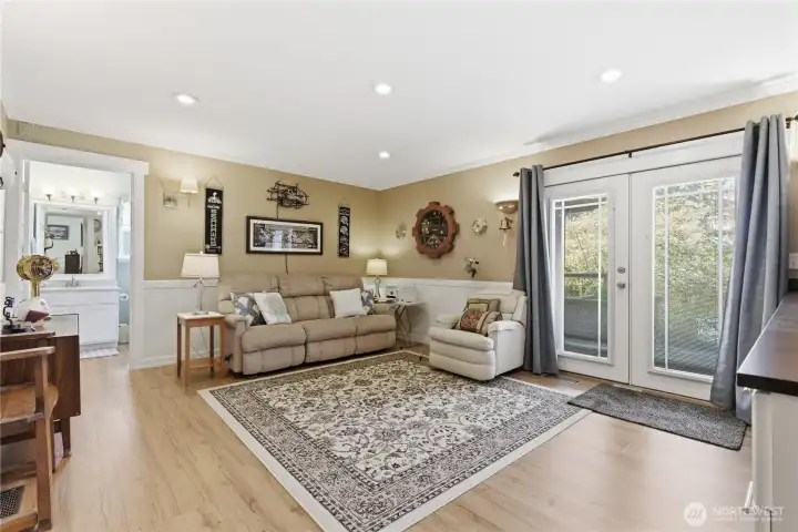 A few steps down is the family room with the conenience of a bathroom. Through the french doors head out to a deck and into the backyard