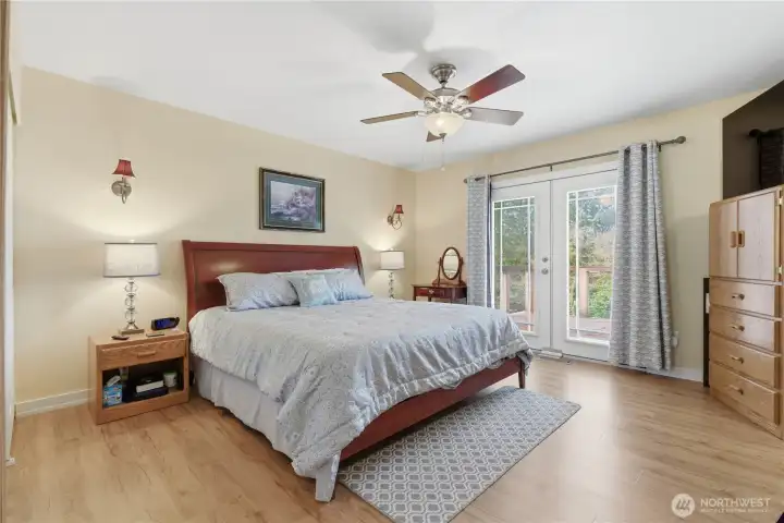 Primary bedroom with French doors to your own west-facing balcony—perfect for unwinding at sunset