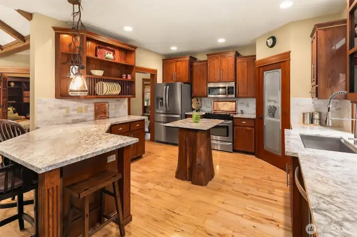 Gorgeous granite countertops, sparkling rustic, maple hardwood floors and tons of cabinetry and space througout this well thought out kitchen