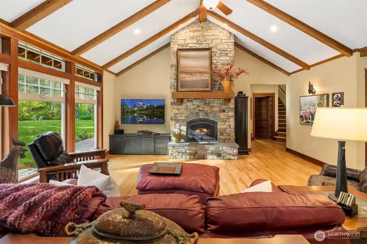 Vaulted ceilings, large picture windows looking out to back yard glory and a lovely rock fireplace to snuggle in front of on a chilly winter eve...