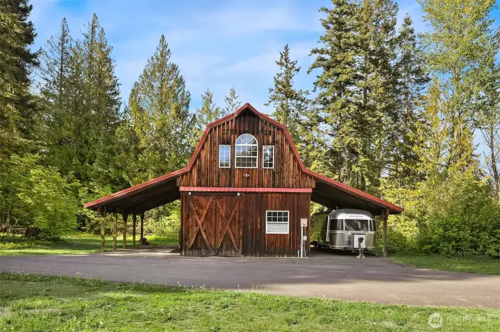 14x26 barn with studio apartment above! Perfect for guests or rental income! RV storage and covered tractor or vehicle parking on both sides of barn.