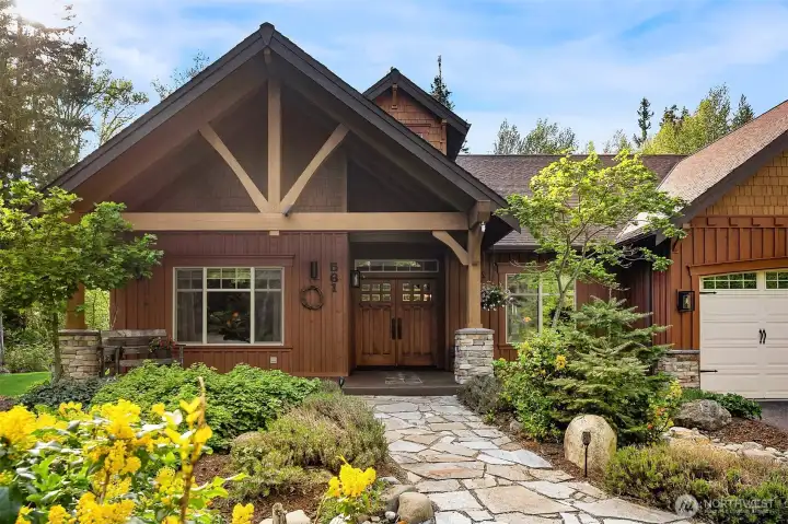 Front entry of home, perfectly landscaped, black topped driveway, rock walkway leads to gorgeous set of front doors