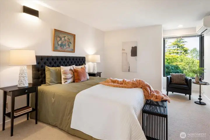 Large primary bedroom w/a double closet also has plenty of room for dressers and a chair to enjoy the view