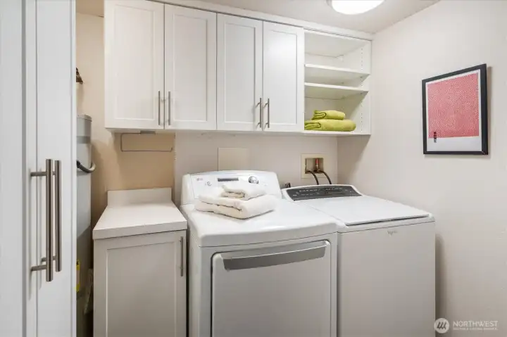 A full laundry room with abundant built-in storage