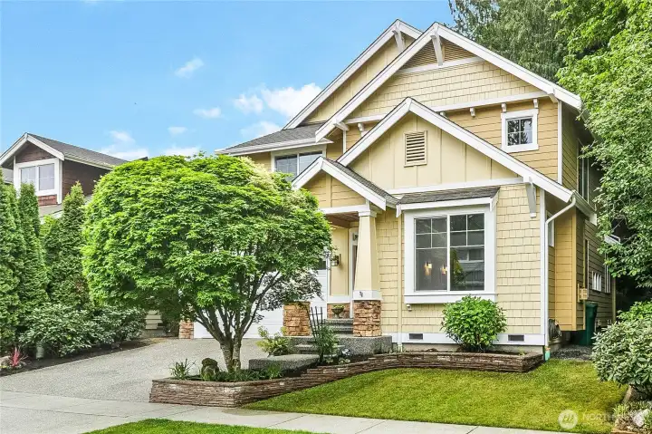 Lovely front landscaping welcomes you home.
