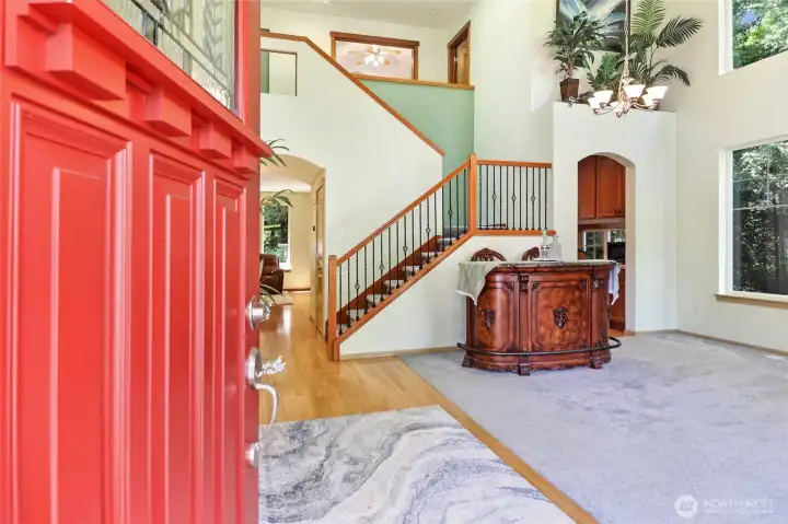 Step from the covered front porch to soaring interiors.
