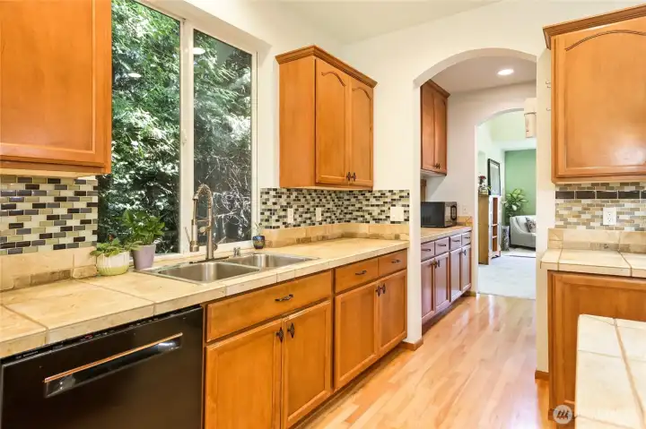 Ample maple cabinets & counter space to accommodate your culinary delights.