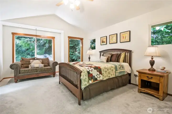 Upstairs, your primary suite feels like a treetop sanctuary with lovely natural scenery at every turn.