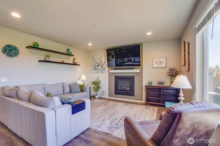 The inviting family room features a cozy fireplace with lots of natural light The inviting family room features a cozy fireplace with lots of natural light