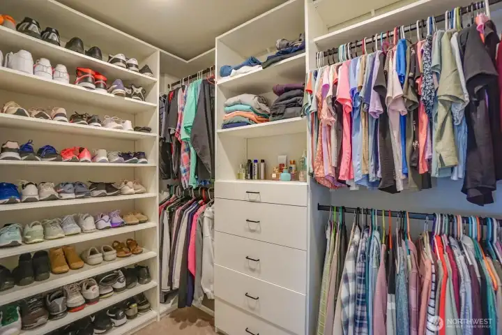 Custom designed closet system in primary bedroom for exceptional organization along with an additional secondary closet Custom designed closet system in primary bedroom for exceptional organization along with an additional secondary closet