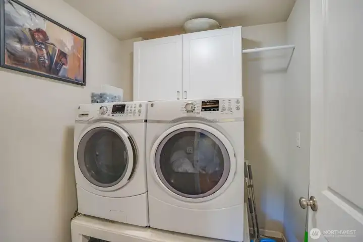 Upper floor utility room with storage and washer and dryer included Upper floor utility room with storage and washer and dryer included