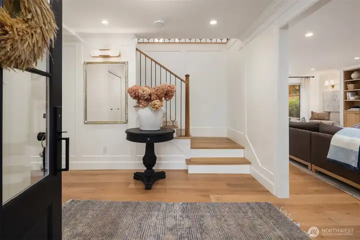 A grand entry opens to the sophisticated foyer with a luxury alabaster wall sconce, custom baluster and millwork. A grand entry opens to the sophisticated foyer with a luxury alabaster wall sconce, custom baluster and millwork.