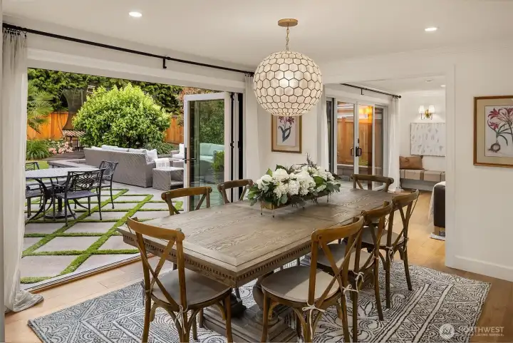 The adjacent dining area features a folding window door for seamless indoor/outdoor hosting. The adjacent dining area features a folding window door for seamless indoor/outdoor hosting.