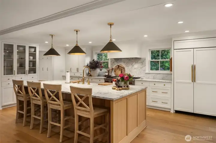Chefs will swoon over the remodeled kitchen with marble surfaces and paneled Sub Zero refrigerator. Chefs will swoon over the remodeled kitchen with marble surfaces and paneled Sub Zero refrigerator.