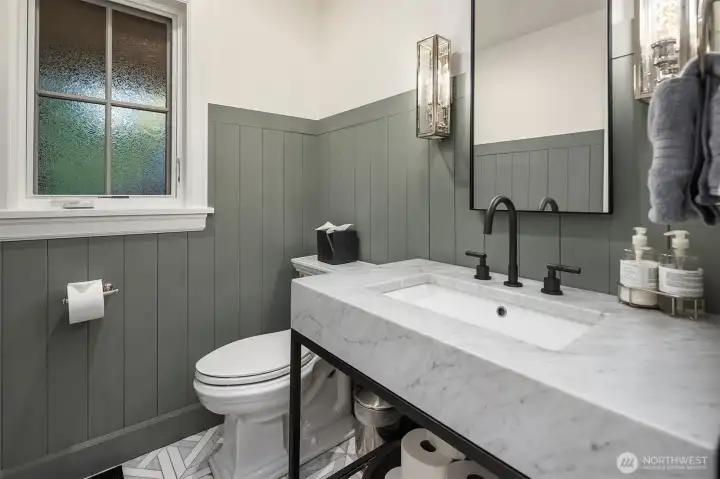 Main floor powder room with marble vanity & flooring. Main floor powder room with marble vanity & flooring.