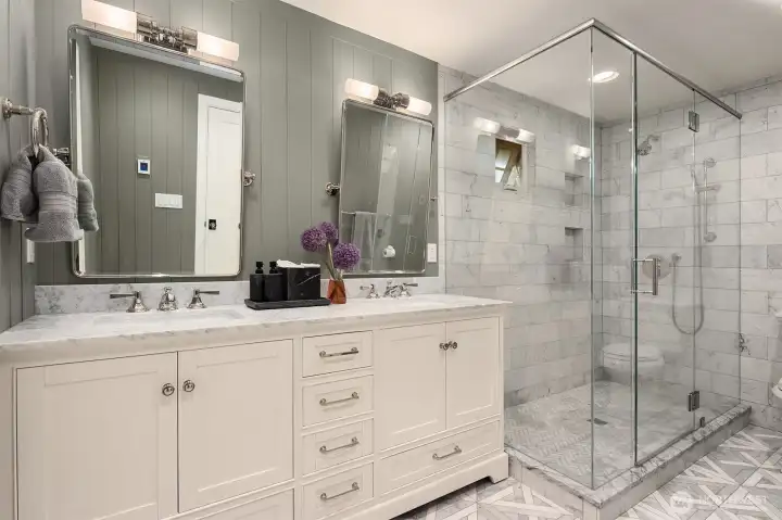 En-suite primary bathroom with marble-topped dual vanity. En-suite primary bathroom with marble-topped dual vanity.