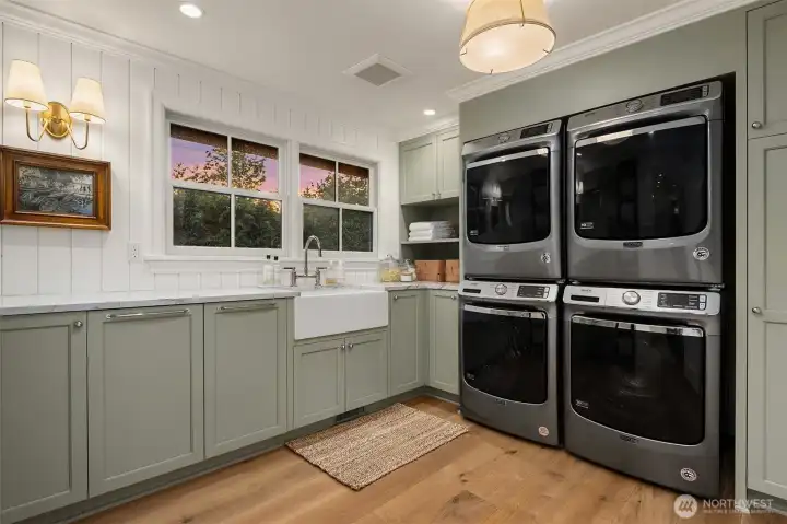 Elevate laundry day with dual sets of washers & dryers, custom cabinetry, & built-in farmhouse sink. Elevate laundry day with dual sets of washers & dryers, custom cabinetry, & built-in farmhouse sink.