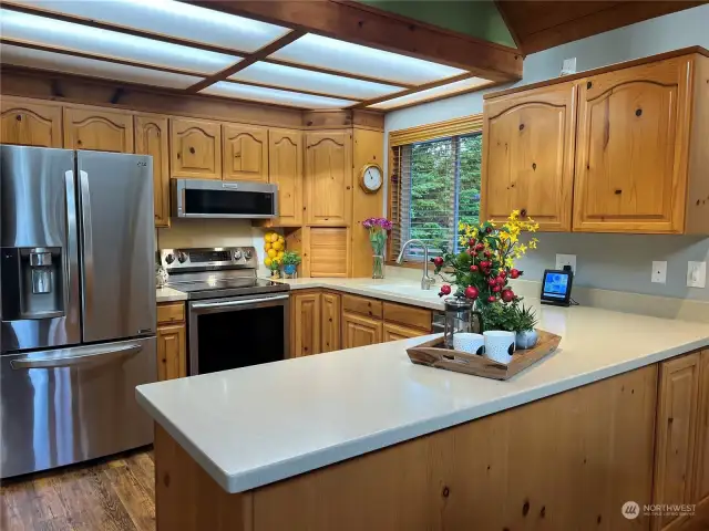 Corian kitchen countertops, stainless steel appliances, and plenty of counterspace and storage.