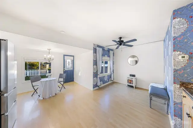 This photo highlights the seamless flow between the kitchen and dining areas, perfect for hosting or everyday convenience. The large window above the sink brings in natural light, while updated appliances and ample counter space make this kitchen both functional and inviting.