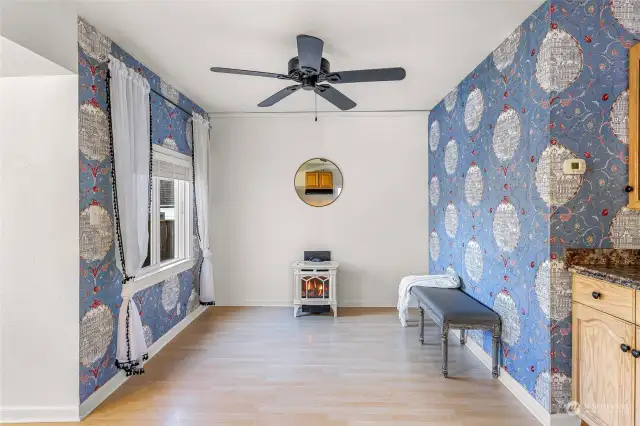 A closer look at the living room reveals elegant design elements, including a decorative wall mirror and charming curtains. The space is thoughtfully laid out, offering potential for various furniture arrangements.