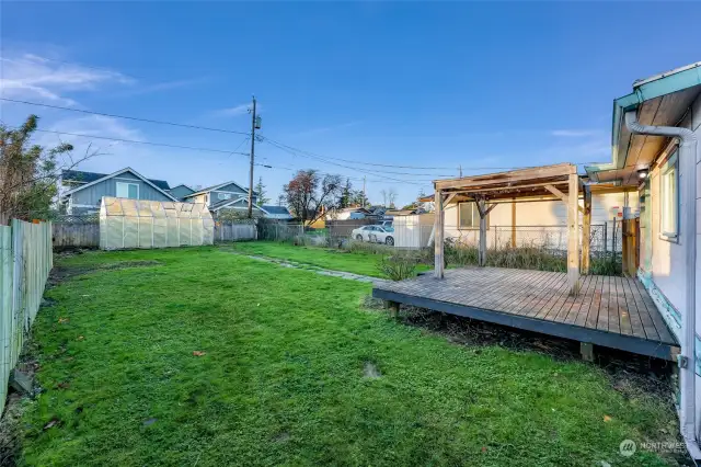 A versatile and expansive backyard that can meet a variety of needs, from hosting gatherings to creating your dream garden space.