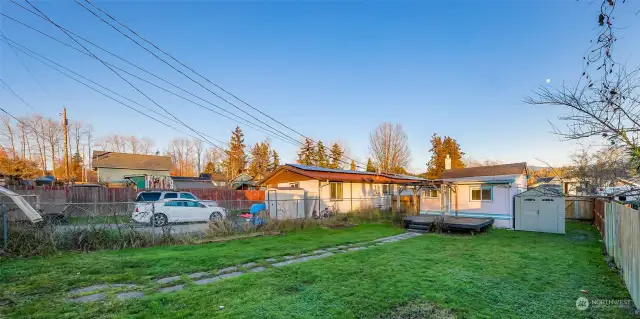 Convenient alley access, ready to add a gate, at the rear of the property, adding functionality and flexibility to the fully fenced yard.