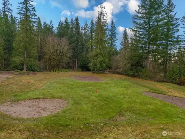 Set near  the Cascade Mountains, this luxurious private home is  nearly 5 acres of lush grounds and lawns that include a  sprinkler system and pitching field range for the golfer.