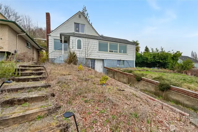Front of home on Isabel Way with large flowerbeds