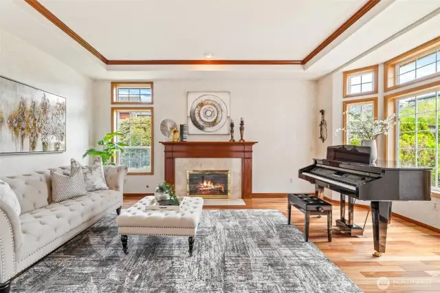 Warm and inviting living room with gas fireplace, wood wrapped windows and beautiful hardwood floors.