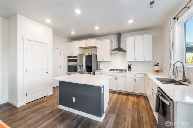 Kitchen with island and quartz countertops.