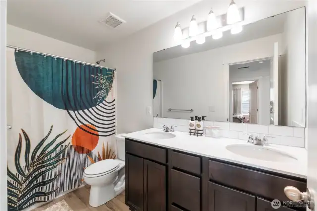 Upstairs guest bath with double sinks.