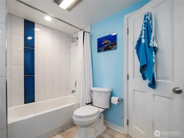 Main floor bathroom with a tiled bath surround