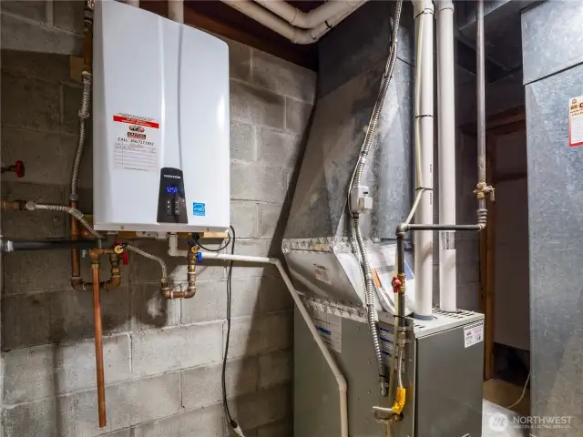 The utility room downstairs contains the tankless water heater and newer gas furnace