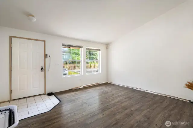-The front room offers a bright welcome to all who enter with its large windows and vaulted ceilings!