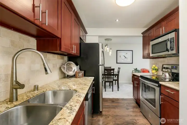 Cherry colored cabinetry beautiful granite counters