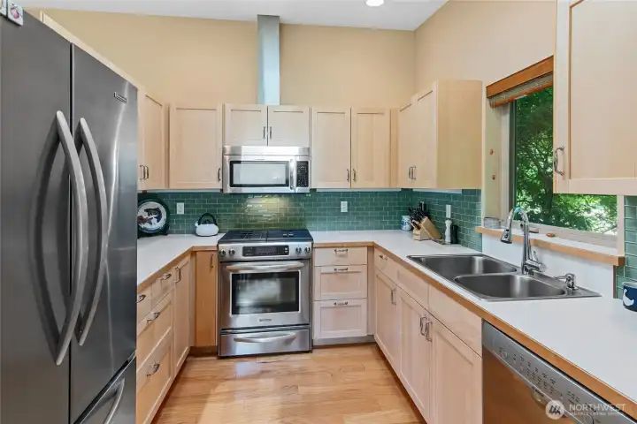 Propane gas range, electric oven, window over sink for natural light.