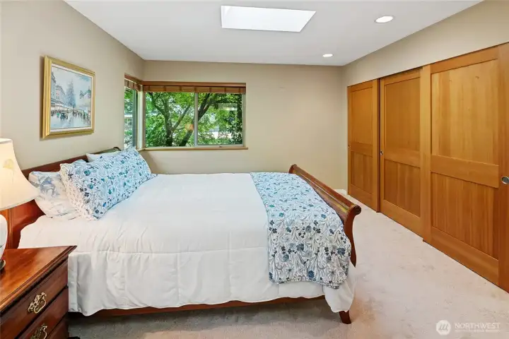 Primary bedroom feels private, lovely wood closet doors, shelving/organizers within closets.