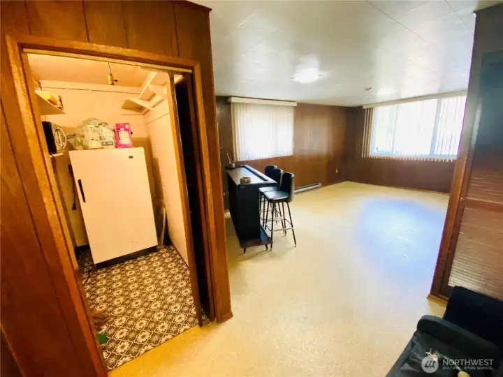 One step down from dining room and kitchen you’ll find a separate pantry with stand up freezer attached to a GIANT bonus room which could easily become an MIL