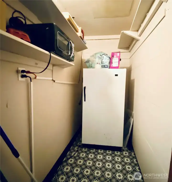 Pantry with room for more shelves along with a great quality stand up freezer which will stay with the house.