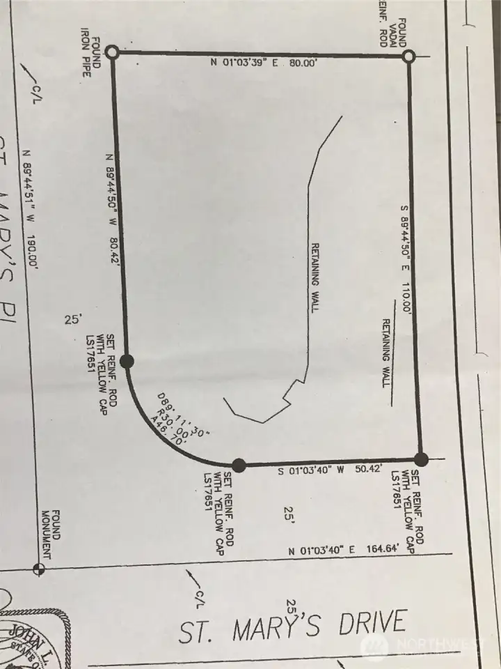 The top of this sketch is facing is west not north. Please note that the northerly edge of the retaining wall is many feet from the property line. While onsite at the street on the east side, look for the mailboxes and you'll see two water meters. This is the property line. (between water meters) The top of this sketch is facing is west not north. Please note that the northerly edge of the retaining wall is many feet from the property line. While onsite at the street on the east side, look for the mailboxes and you'll see two water meters. This is the property line. (between water meters)