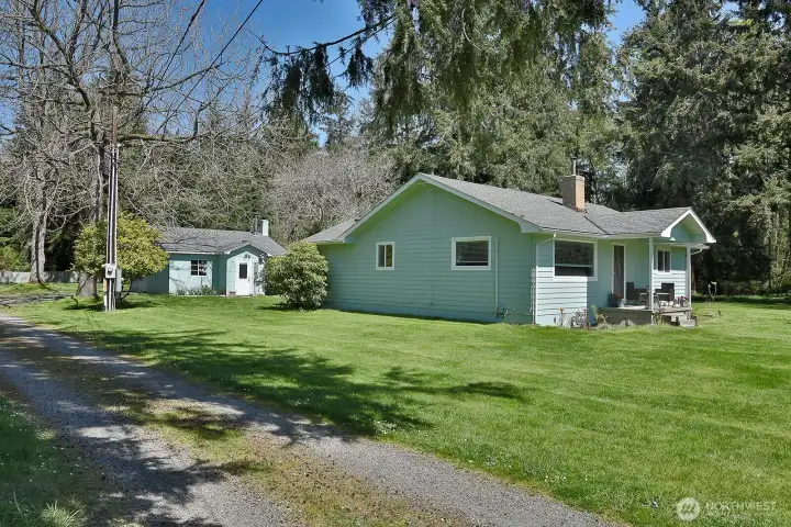 main home with detatched garage/shop in background