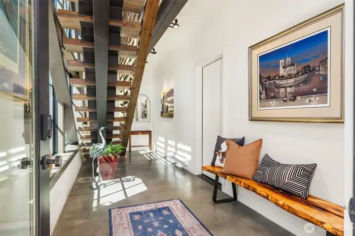 Entry with steal beam steps, garage on the right and elevator