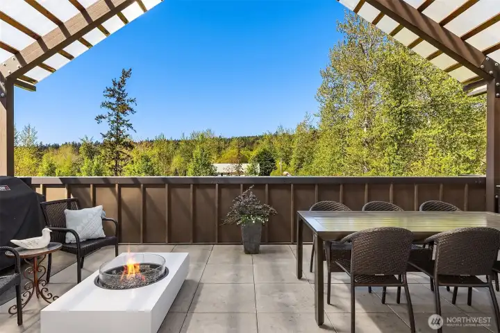 The massive patio balcony faces south and captures warm afternoon light.