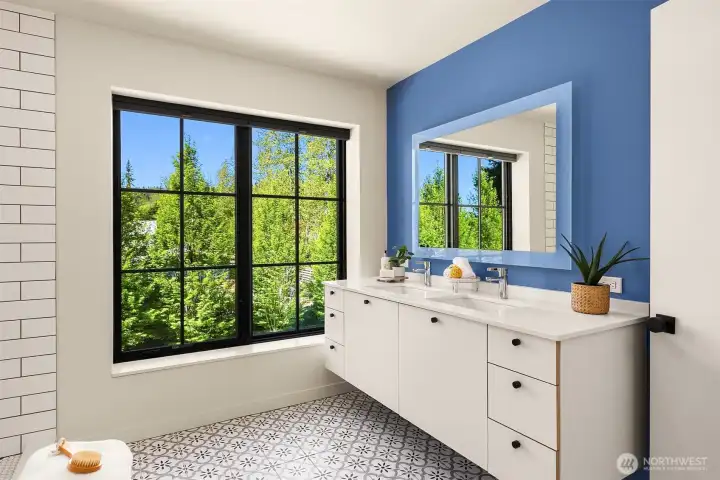 The primary bath lets in plenty of light and includes a lighted fog freee mirror