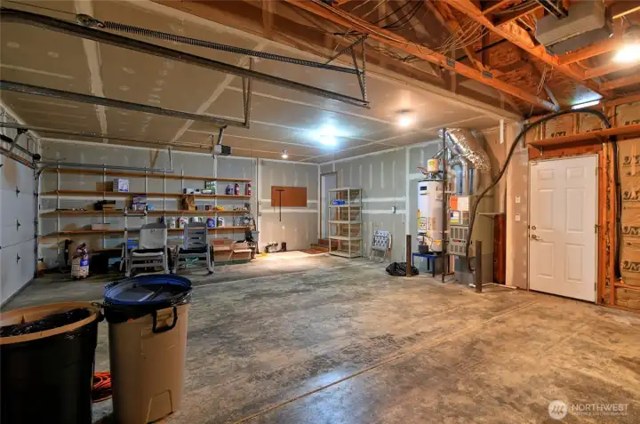 Three car garage, door goes to back yard.