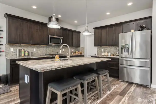 Welcome to your beautiful new kitchen! The seller had professional pull-outs and even very heavy duty custom shelving to house bottles of adult beverages so don't miss it to the left of the sink when you're touring the home!