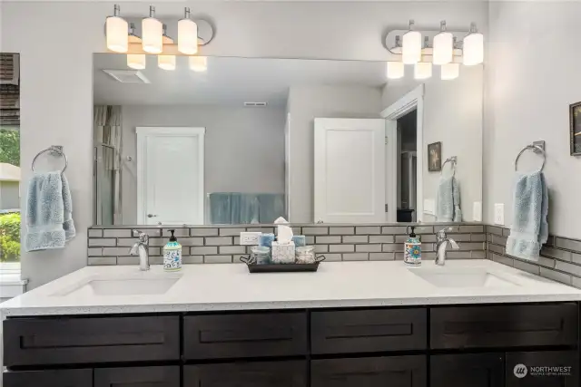 Double vanity in the primary bath, with granite counters.