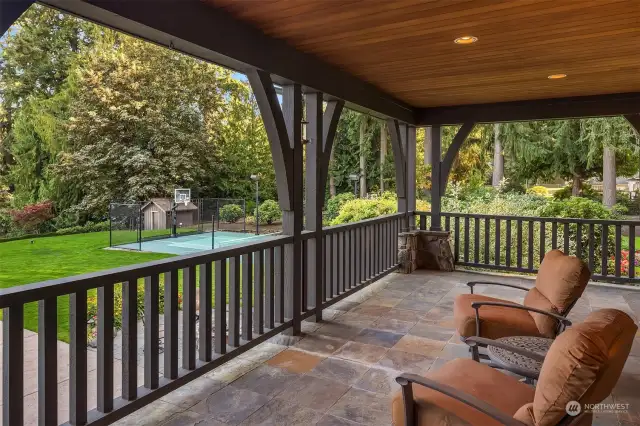 Covered porch off of the kitchen with terraced views of the property